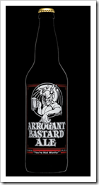 photo of a bottle of arrogant bastard ale against a black background.  